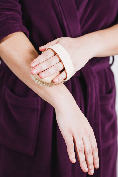 Close-up of a hand using the body brush